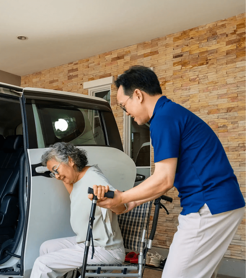Caregiver helping senior with walker