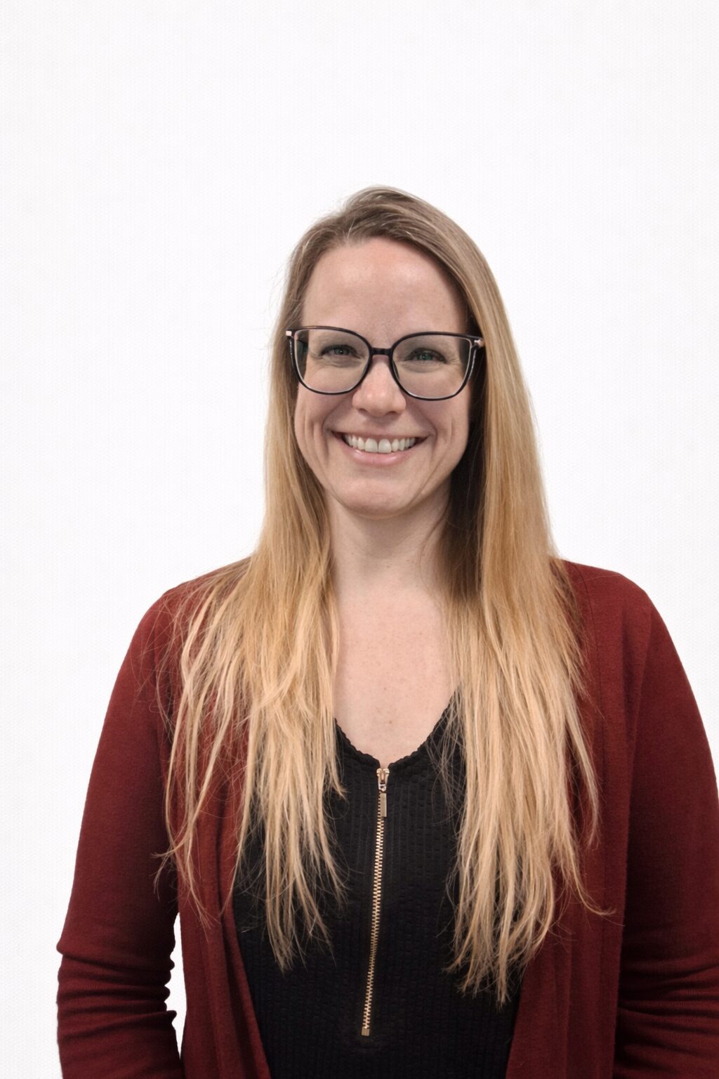 Smiling woman with long blonde hair and glasses