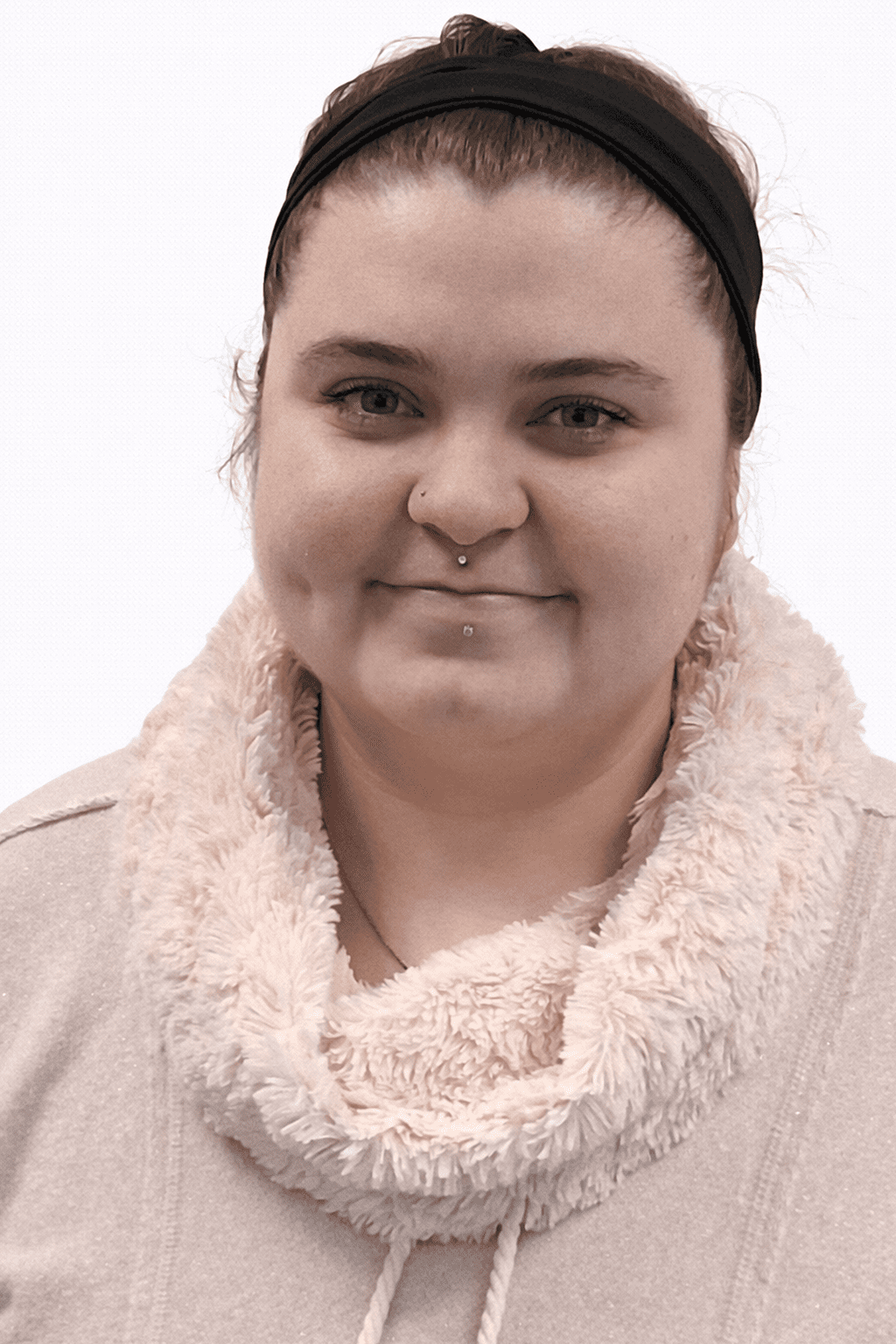 Portrait of a woman smiling softly in a cozy beige sweater.