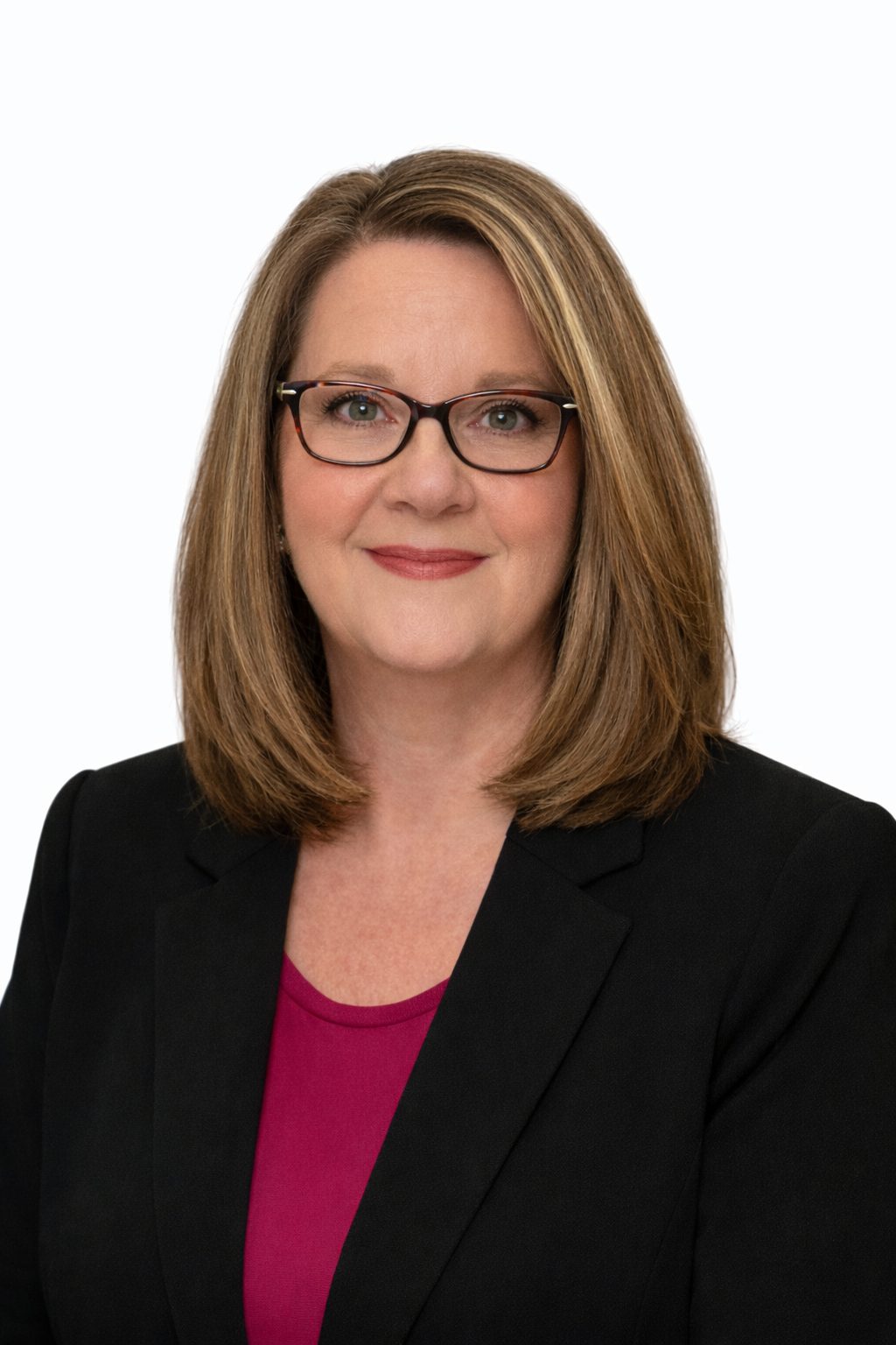 Professional woman with glasses smiling in business attire.