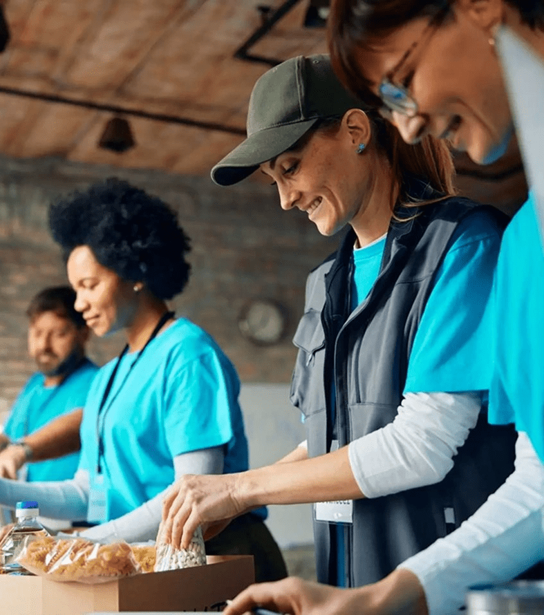 Volunteers preparing food together in a community kitchen.