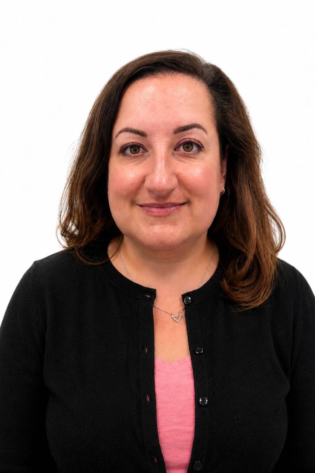 Smiling person in black cardigan and pink top