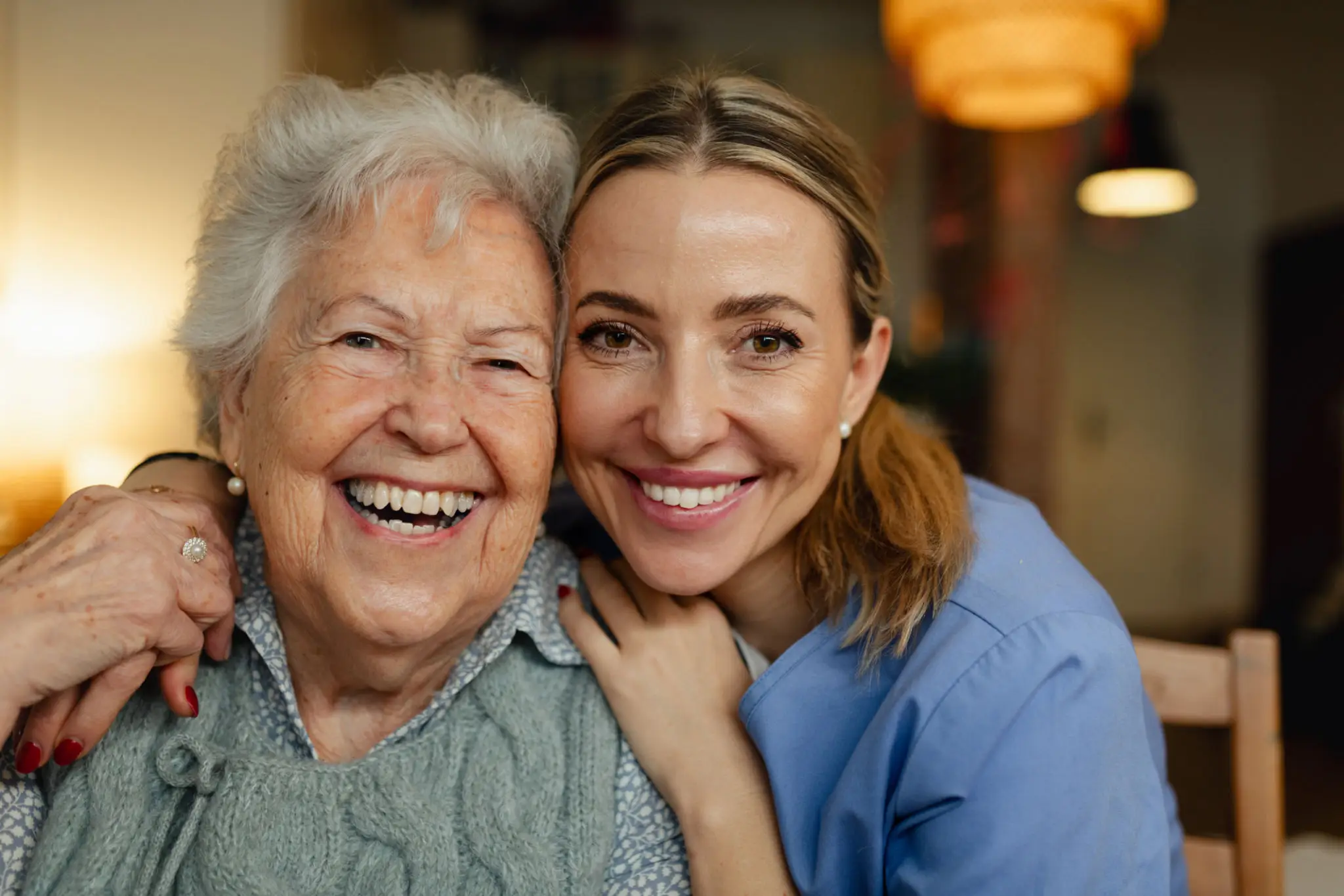 Older woman and caregiver smiling together