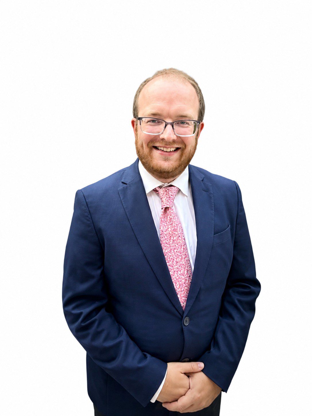 Man in a suit with a cheerful expression.